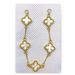 Gold-tone five-cross bracelet with white pearl-look inlays displayed on a card inside a white organza gift pouch.