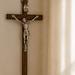 4.75-inch wood wall Crucifix with detailed carving of Jesus on the cross, Catholic devotional wall decor suitable for sacraments and home prayer spaces.
