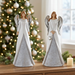 Both 8-inch angels displayed together in a Christmas setting