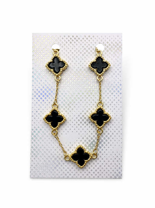 Gold-tone bracelet with five black enamel-look crosses displayed on a silver-patterned card inside a white organza gift pouch.