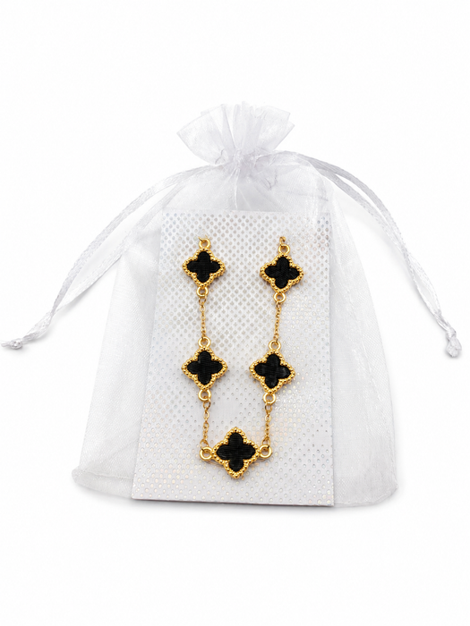 Gold-tone bracelet with five black enamel-look crosses displayed on a silver-patterned card inside a white organza gift pouch.