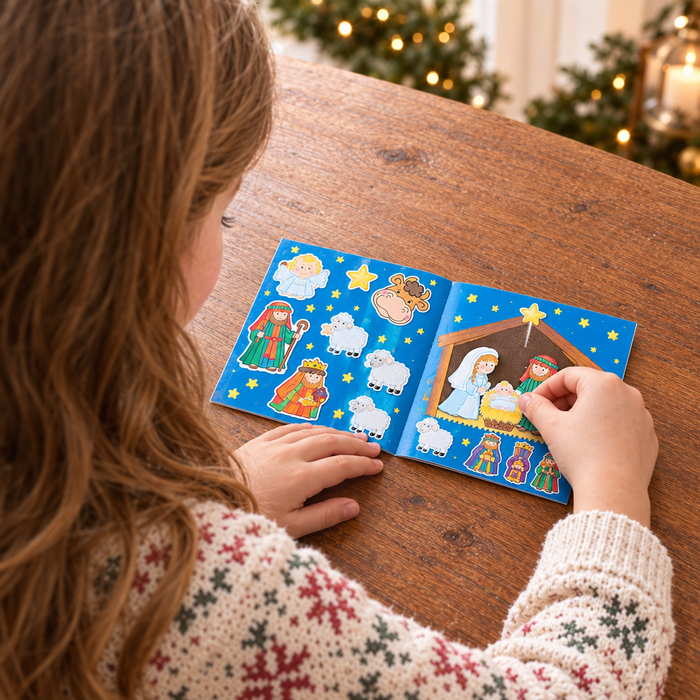 Over-the-shoulder view of the girl using the Nativity sticker book