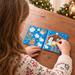 Over-the-shoulder view of the girl using the Nativity sticker book