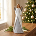 White angel figurine in a warm Christmas setting